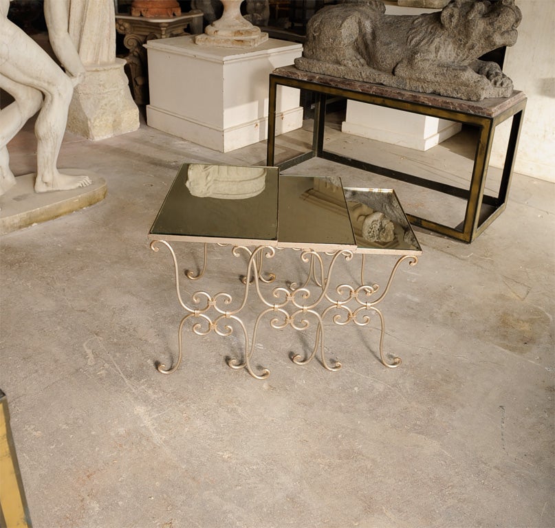 Stylish Set of three nesting tables w/ mirrored tops and painted metal frames w/ platinum finish.