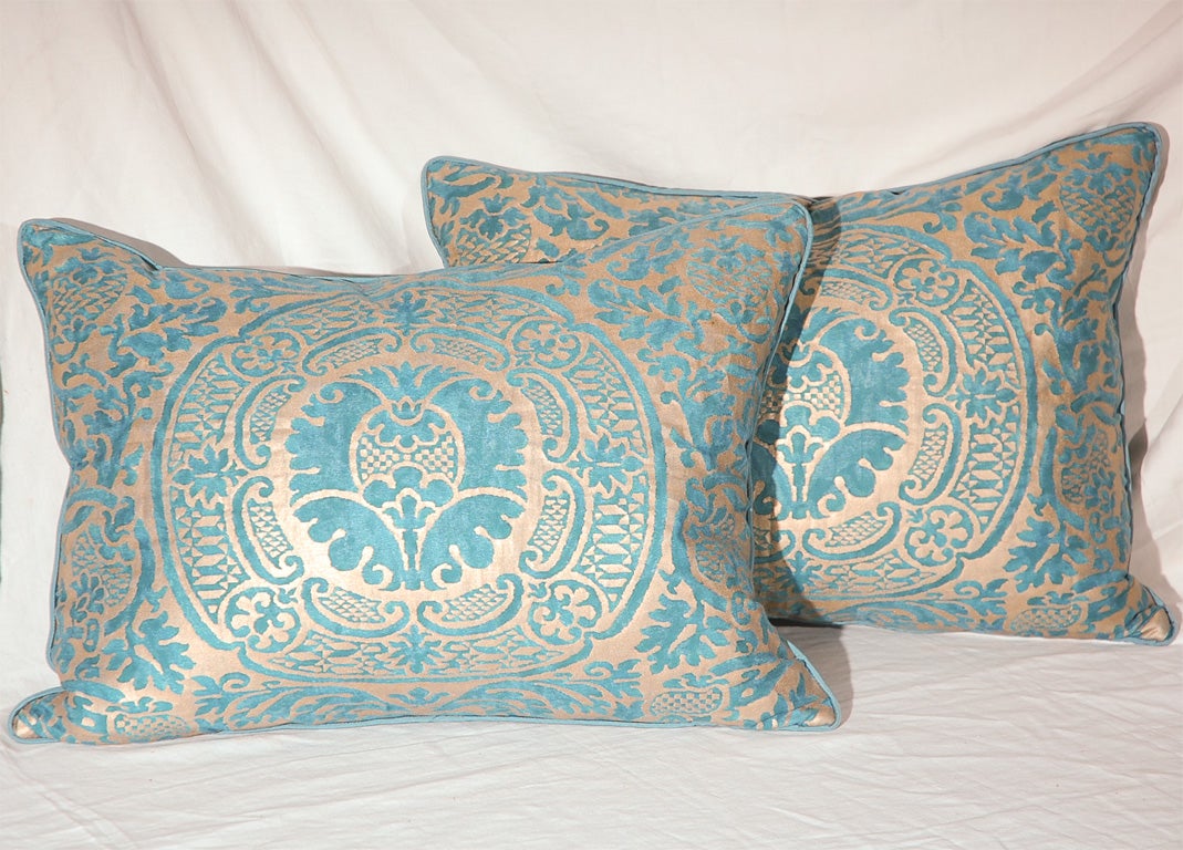 Description: Subtle authentic Fortuny pillows hand stamped in metallic silvery gold on an striking teal blue background in the 