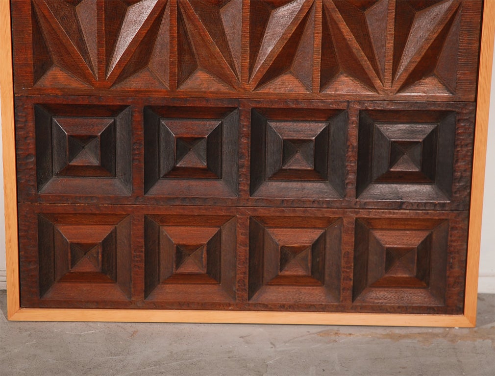 This panel is actually a grouping of nine smaller panels, which fit together with tongue-and-groove joints, all framed together. California-based Panelcarve (which grew into a more famous company called Forms + Surfaces) produced carved modular