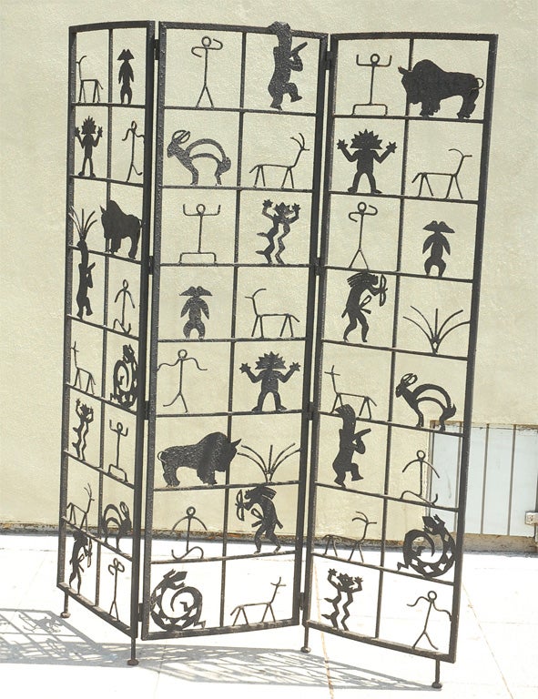 Three panel room divider embellished with tribal images.
