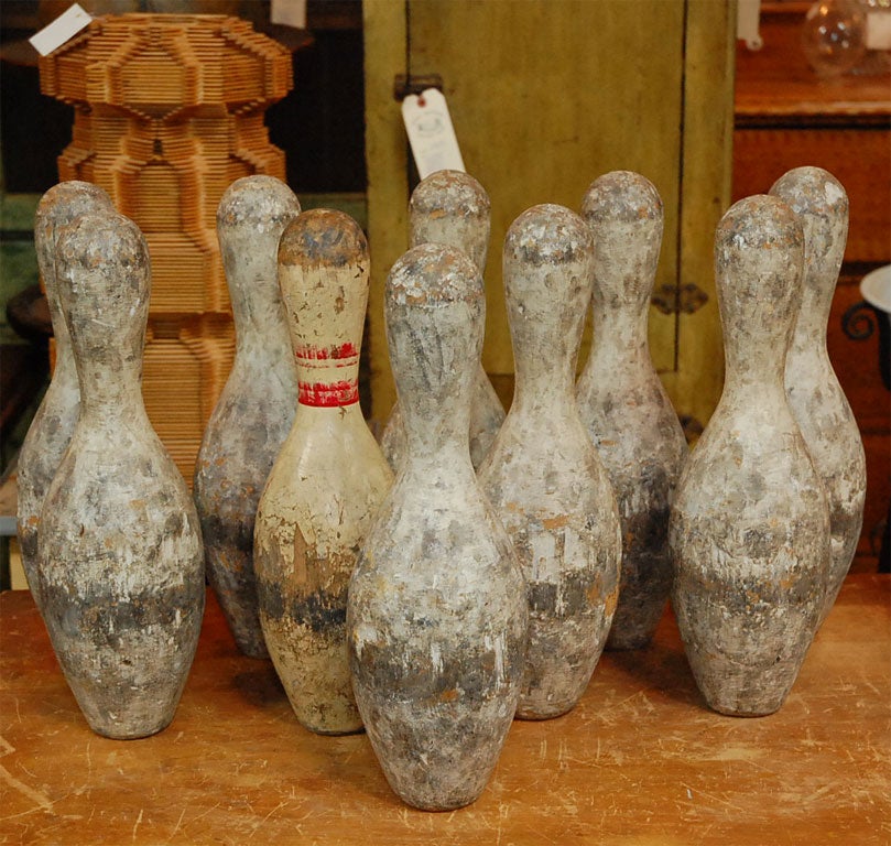 Set of 10 painted C. 1930 wooden bowling pins. Perfect for the folk art collector, or just as an art statement in any decor.<br />
No ball included.