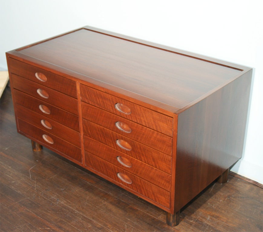 Beautifully made ten-drawer chest of Italian walnut with oval cut-out drawer pulls and bullet legs. Second matching chest is also available.

Illustrated: Gramigna. 