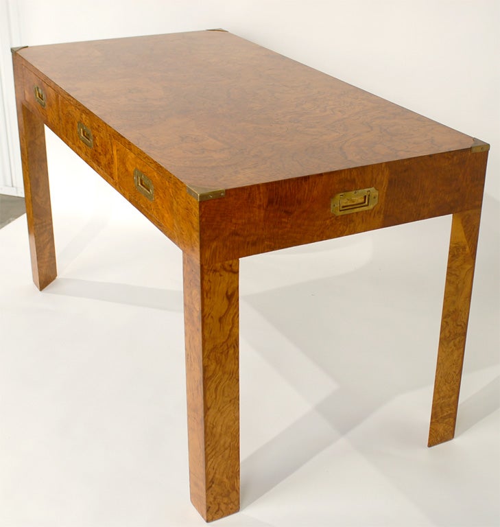 Burled olivewood campaign desk, Italian, circa 1960's. Simple, yet elegant design. The brass hardware retains it's original warm patina. If you desire, we can polish it to a high sheen for an additional charge. Three deep drawers offer a voluminous
