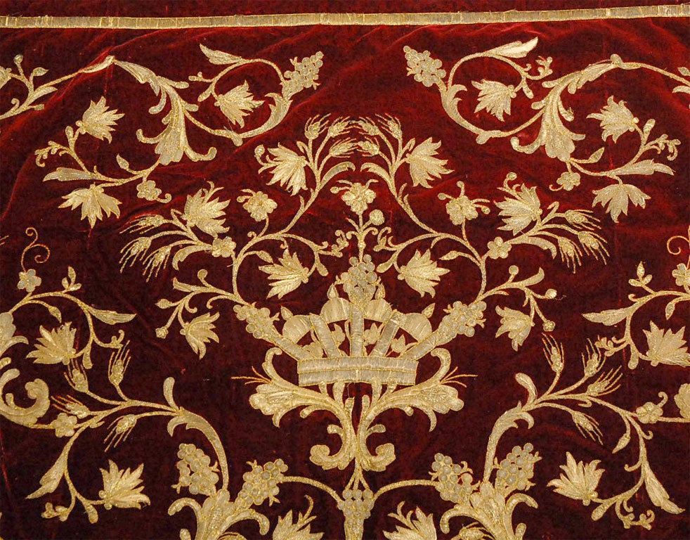 A rich background of crimson silk velvet contrasts beautifully with the gold & silver metallic threads used in the embroidery applique.  The bold center crown is encircled with a bounty of wheat, grape clusters, acanthus leaves, and flowers.  The