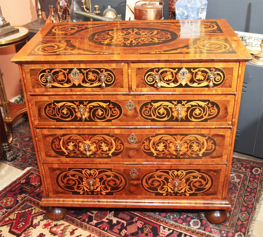 Fine and rare William and Mary walnut and marquetry five-drawer chest on bun feet.