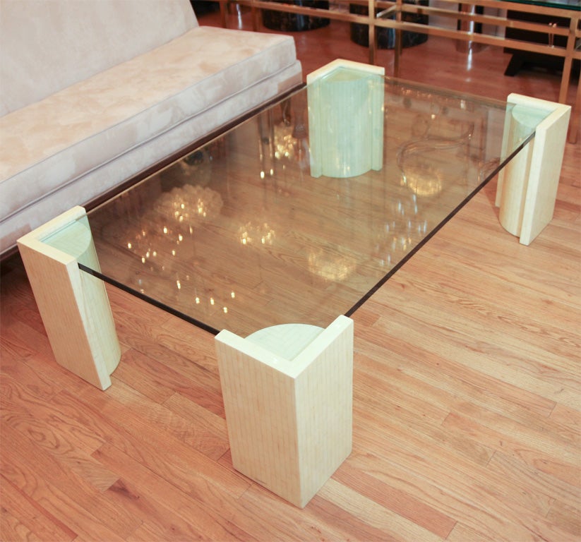 Glass top cocktail table with bone inlay corner supports