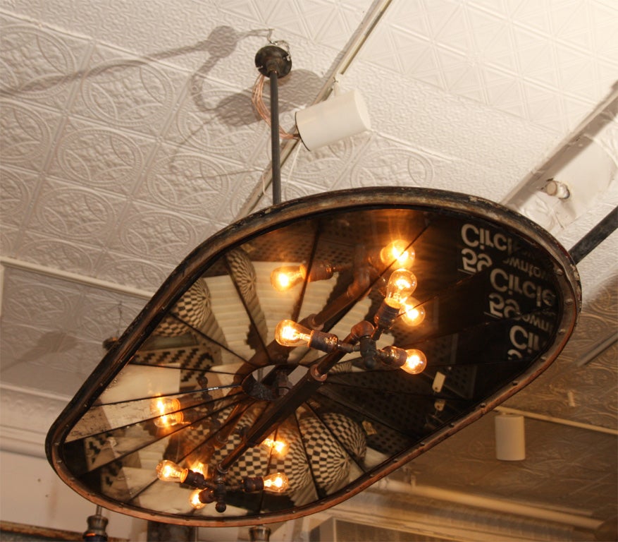 Large oval riveted iron silo lid from the Remington gunpowder factory in the Connecticut Valley. The lid has been repurposed with faceted mirrors and wired for 6 lights.