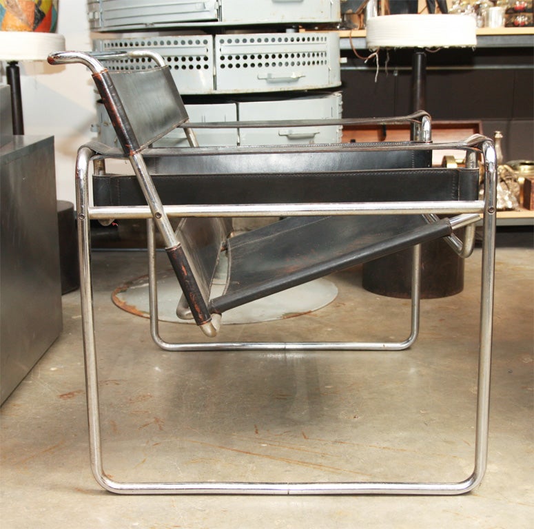 A pair of wonderful 1970s Marcel Breuer designed Wassily chair in black leather with interesting patina.