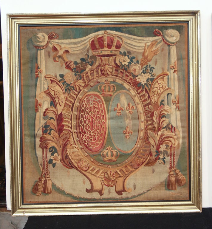 A PAIR OF TAPESTRY PANELS. THE COATS OF ARMS ARE RELATED TO THE KING OF NAVARRE (CHAINS AND FLEURS DE LYS CENTERED IN THE SHIELD) AND THE SAVOY FAMILY (THE INSCRIPTION FERENDO ABOVE LIONS HOLDING THE SHIELD). FRAMED IN MODERN GILT-WOOD FRAMES.