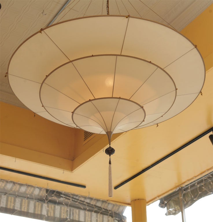 Three concentric rings of silk, supported on silk rope, create a soft, even glow to this fixture, designed by Mario Fortuny in Venice.  A contemporary creation, produced in Italy by the Fortuny Sudios.