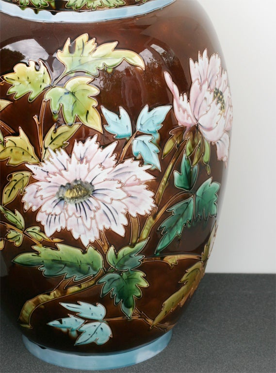This is a very decorative Majolica large scale vase with Aesthetic Movement tube-lined decoration, 19th century. Each flower is outlined with impasto borders and hand painted with colorful enamels. The decoration completely encircles the vase and it