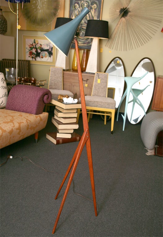 SOLD AUGUST 2009 Designed in 1954 by brothers Uno & Osten Kristiansson for     Luxus of Vittsjo, Sweden, this teak tripod floor lamp with an articulating enameled metal conical shade is a graceful delight.  Sensuously and delicately shaped warm