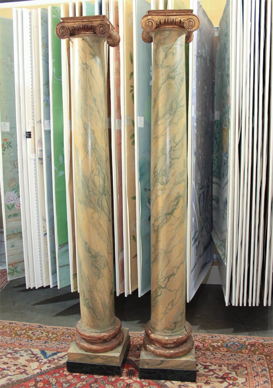 A pair of mid 19th century Italian wood Doric columns retaining the original very theatrical painted marble finish. 