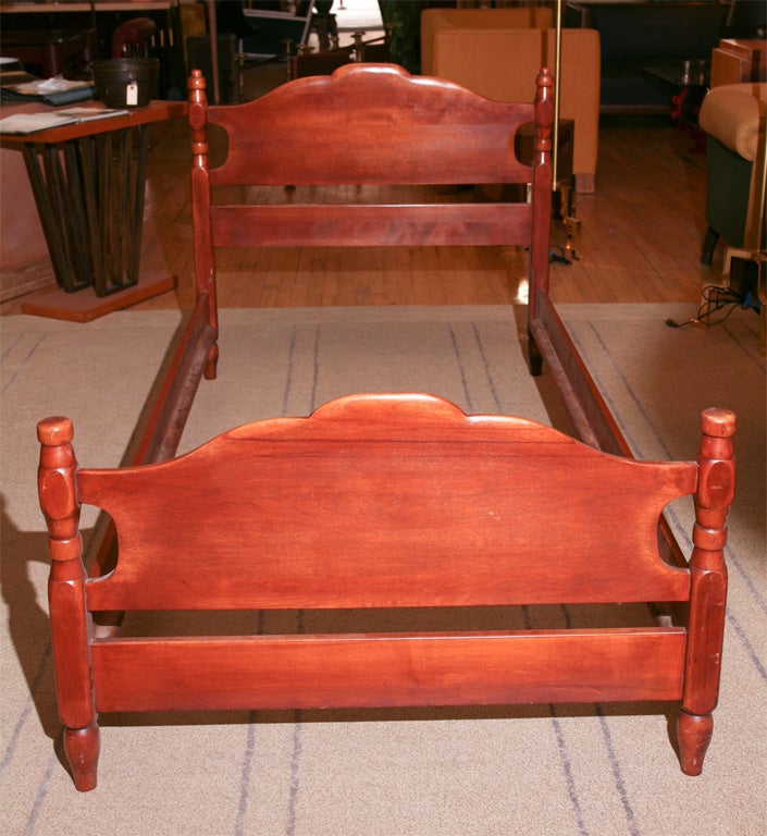 A matched pair of twin beds, in maple finish, with colonial styling and strong modern lines. Produced by Cushman.