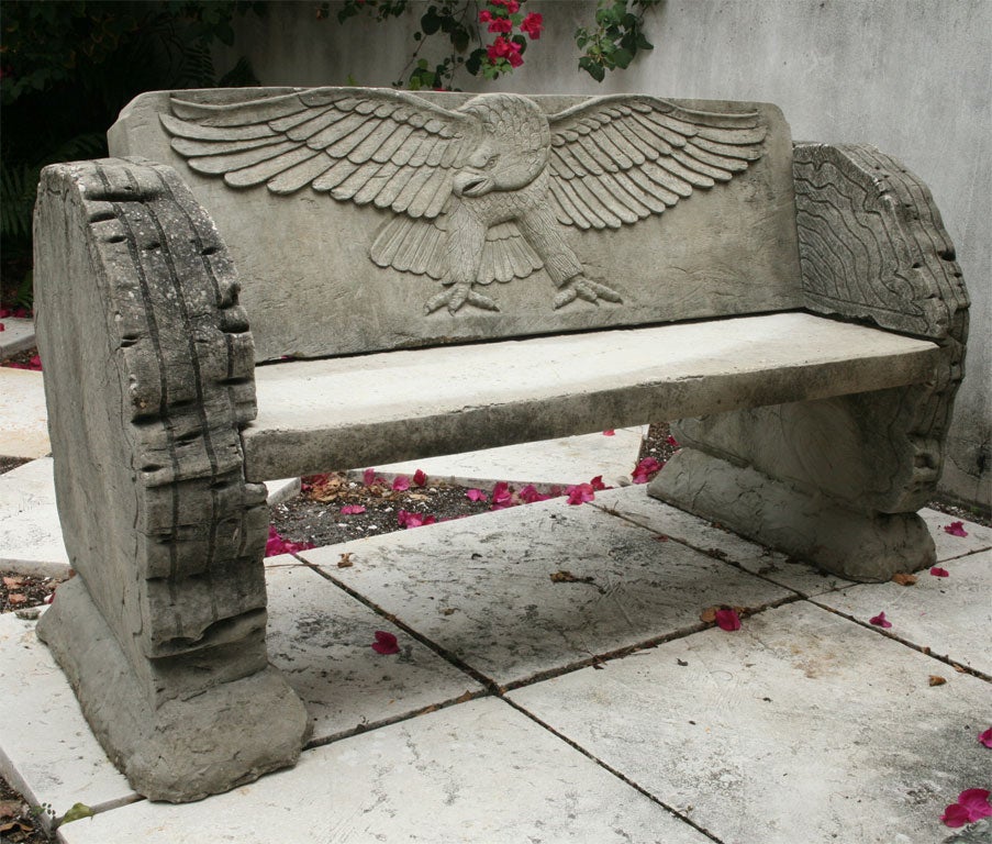Pair of unusual cement garden benches with eagle and log motif.