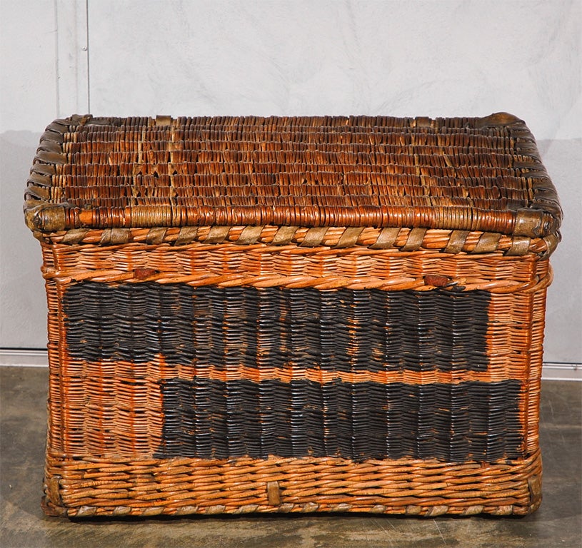 A large woven wicker basket or trunk, probably English, circa 1910. Well used but still sound and in good condition with some surfaces painted over and the number 469 visible in black paint. <br />
Jefferson West Antiques offer over 3,000 items of