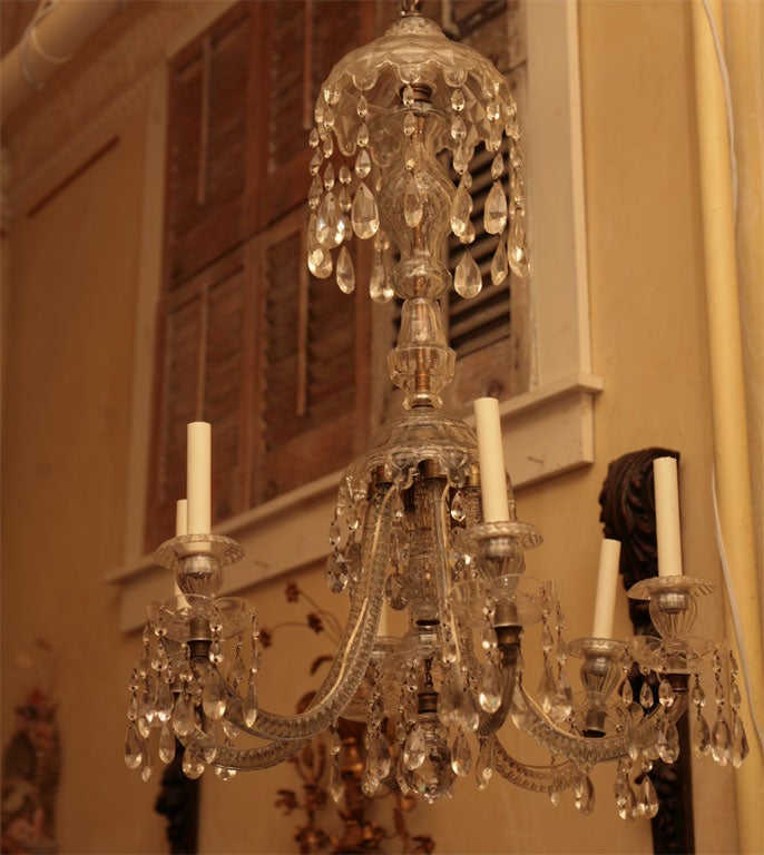 This very nice chandelier of the Georgian period has some later additions and a professional repair to one arm. The design is very nice without being to over the top and the cutting to the glass is of the finest quality. The restrained use of