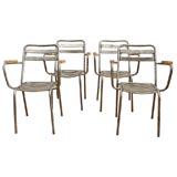 Set of four polished steel armchairs.