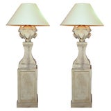 Large architectural stone lamps on matching plinths