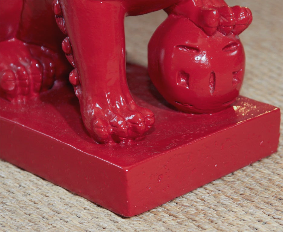 Pair of red lacquered composition lamps in the form of Chinese lions