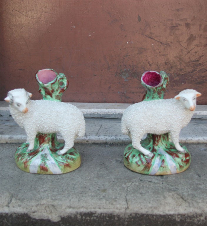 A wonderful pair of antique English Staffordshire spill-vases in the form of ewes.