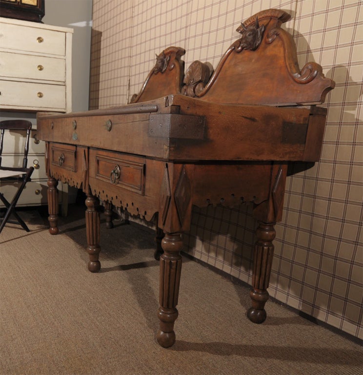 19th c French butcher table with two front working drawers and pair iron bulls' heads mounted on double back piece; metal plaque in front stating manufacturer in Lyon, France.
