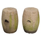Pair of weathered and worn stone garden stools.