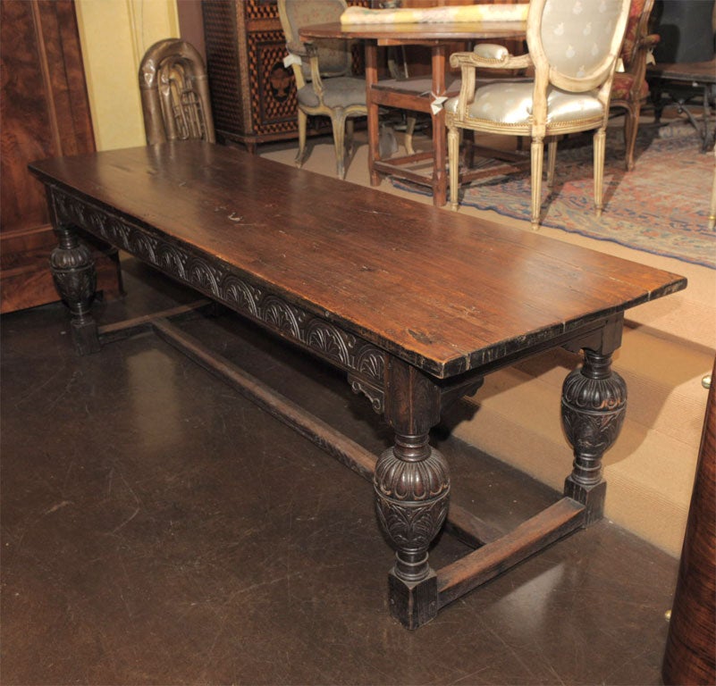A LARGE HANDSOME OAK DINING  TABLE WITH BEAUTIFULLY CARVED BULB LEGS AND APRON,ENDING IN AN  H  STRETCHER.