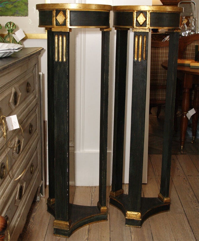 Pair of pedestals with black lacquer finish and gilding. Tripod legs with fluting at top.