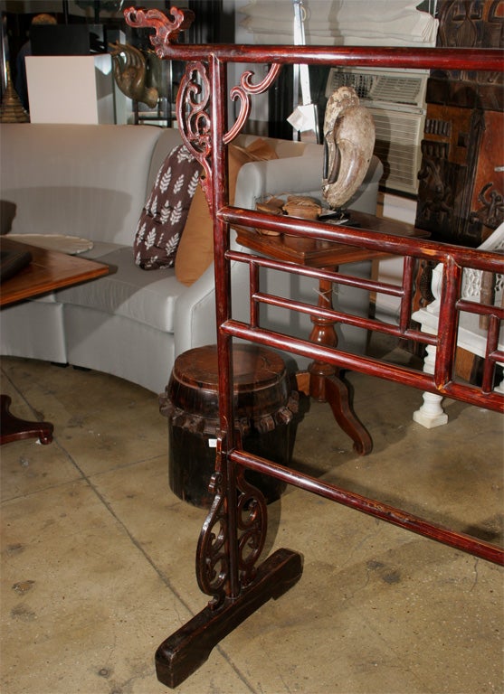 A traditional elmwood robe rack from the Shanxi area and 19th Century. Suitable as a clothing rack, headboard, or divider.  Traditional oriental features include dragon heads on each top corner.