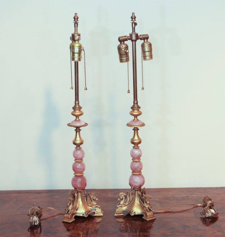 The rose quartz beads alternating with ormolu disks and mounted on a quadripartite plinth mounted with busts of Pegasus.