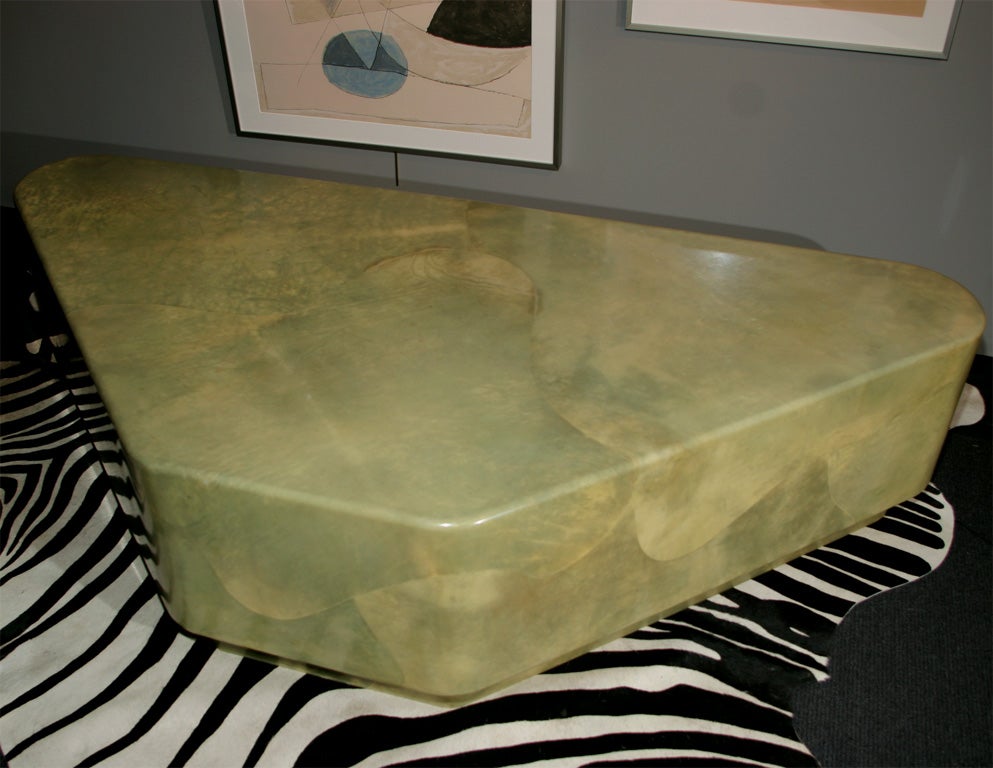 A wonderful goat skin cocktail table in a wedge shape and in a light jade-like green color. Skins are covered with a thick laminate.
