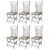 Used set of 6 outside garden iron chairs with cushions