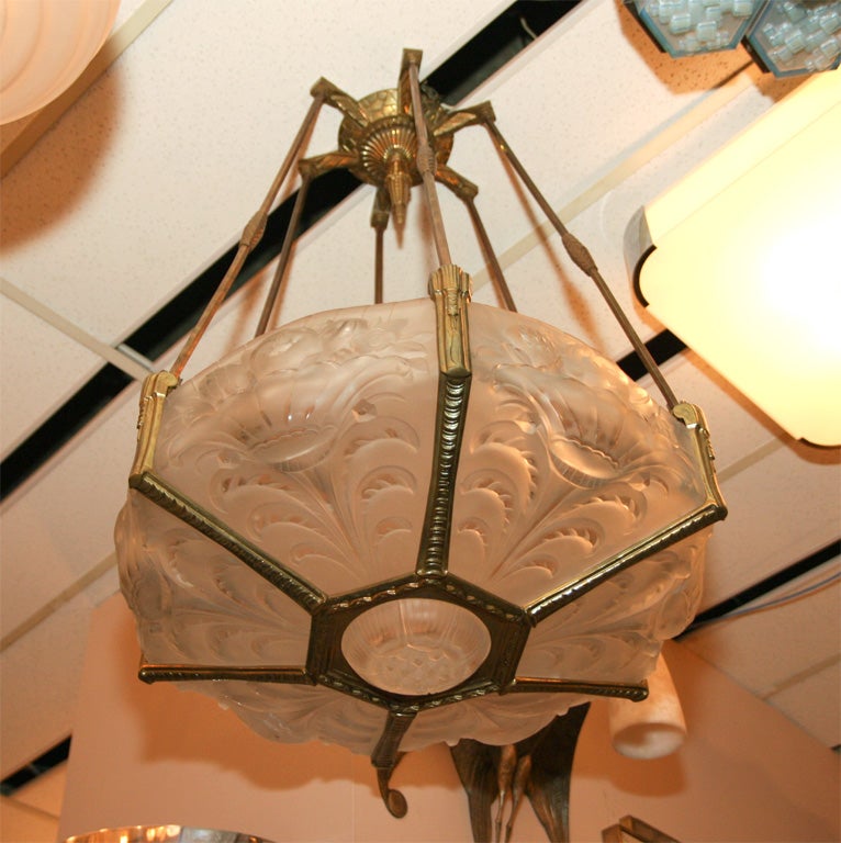 A Verrerie Belge deco chandelier in clear and frosted molded glass and gilt brass, circa 1930s.