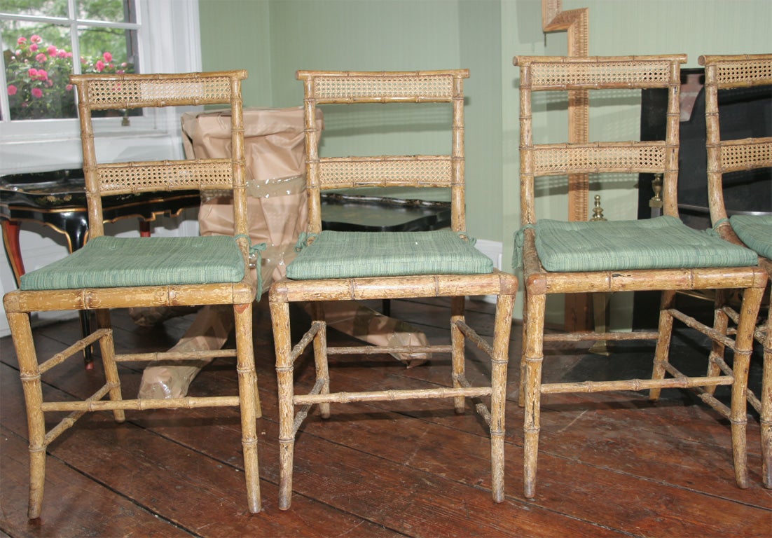 Set of four Regency klismos form painted and bamboo turned side chairs with double caned panelled back and seat. Original surface decoration. English, c. 1810 PROVENANCE: DORIS DUKE COLLECTION