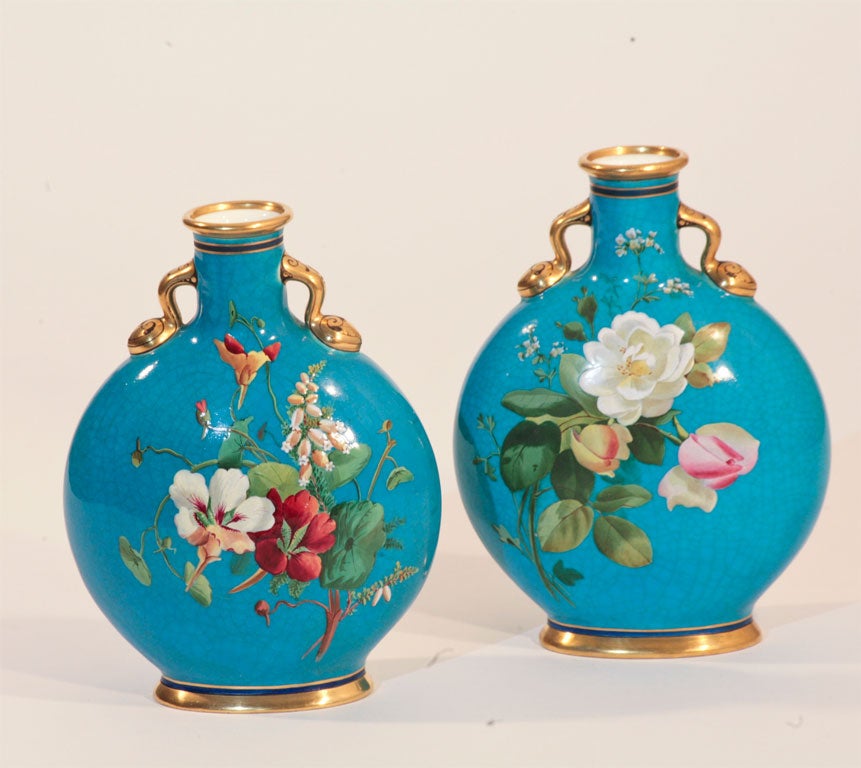 Pair of Minton Aesthetic Movement Pillow Vases with hand painted enamel floral decoration on a turquoise ground. Both the front and back are painted with realistic and vibrant colored flowers. Each side is uniquely painted. The gilded dolphin