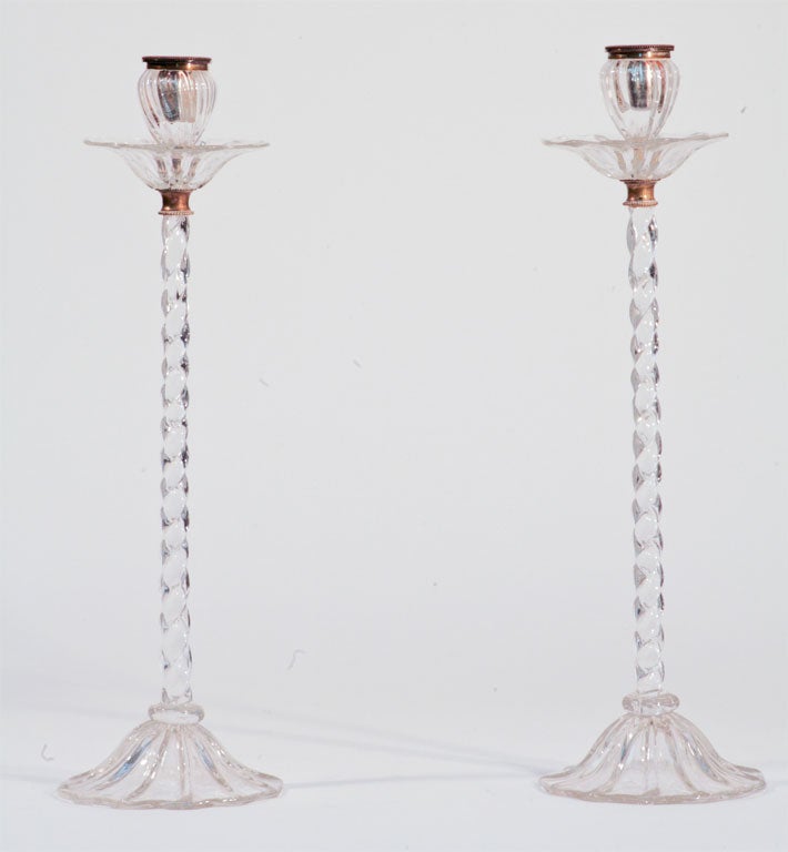 Pair of Webb hand blown crystal candlesticks with wrythen stems and cupped foot. These magnificent candlesticks have brass mounts with separate optic rib blown bobeches that sit below the candle holders. The cups are also made of brass which