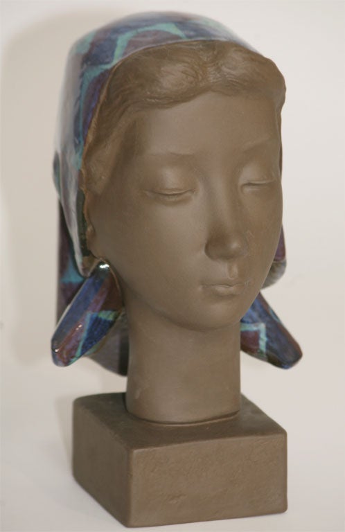 An exceptional terracotta bust produced at Alumina, a Danish factory established in Copenhagen in 1863, later becoming Royal Copenhagen, by Johannes Hedegaard (1915-1999). This female bust features elements of Hedegaard's famous forms and color