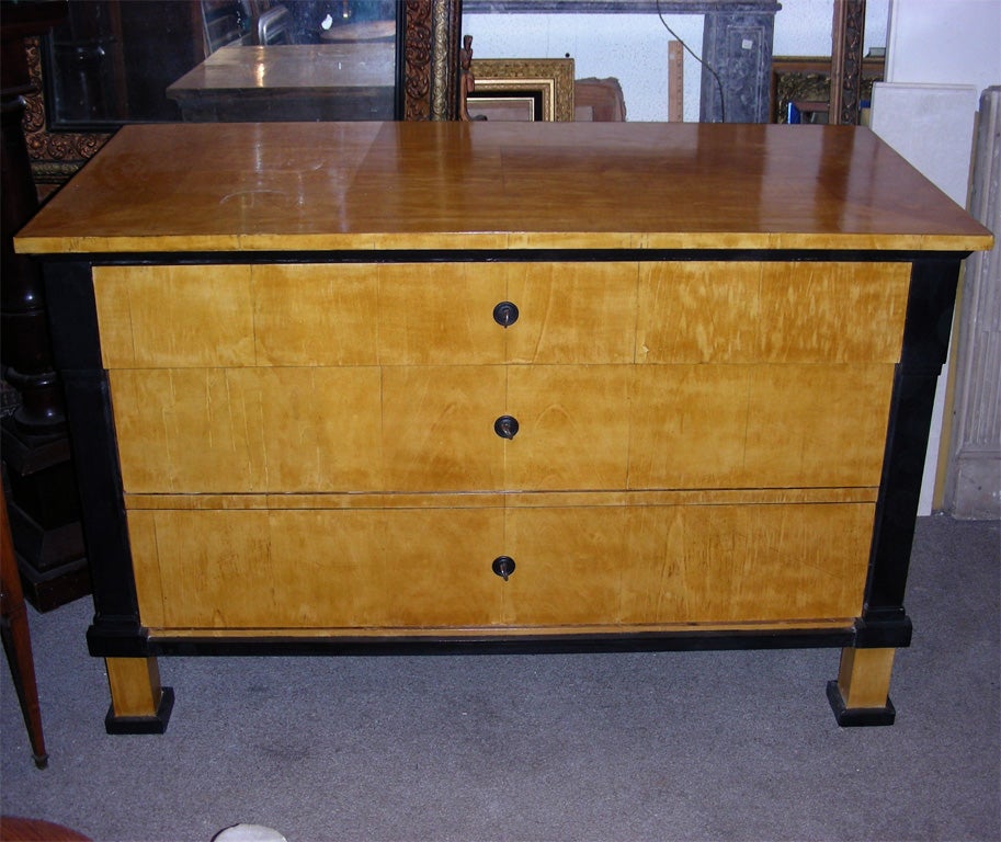 19th century Biedermeier style commode in sycamore on pine with dark wood elements. Three drawers.