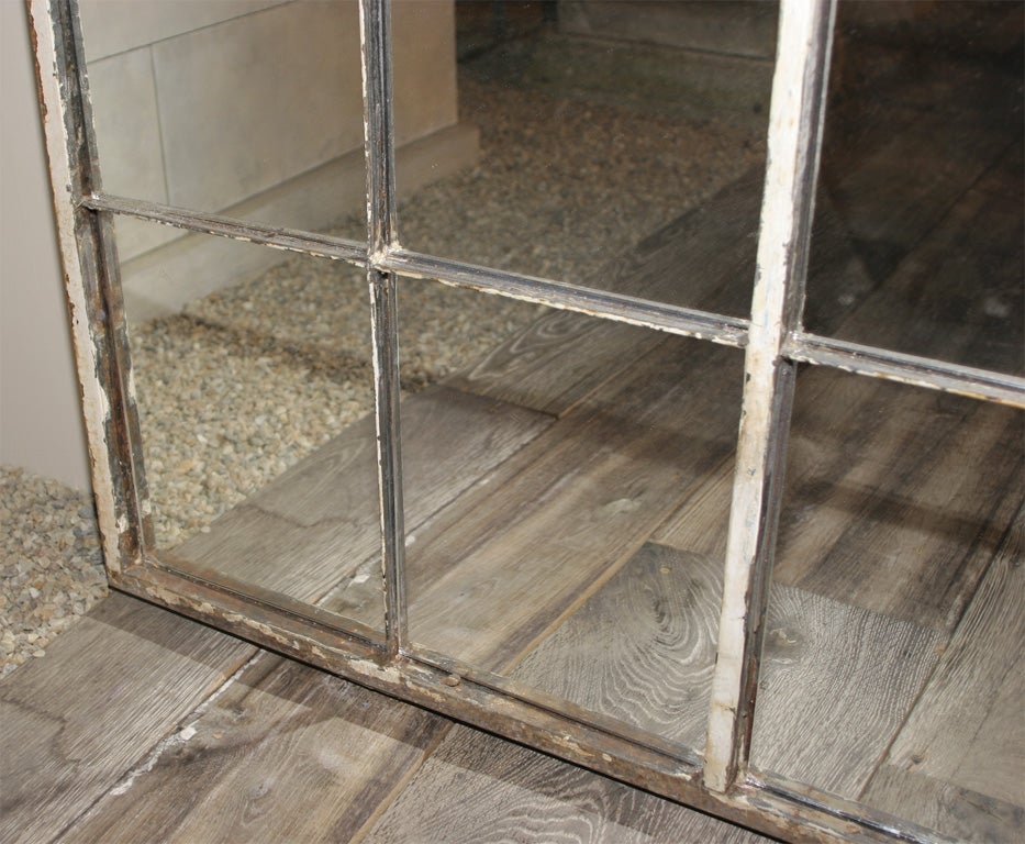 This steel window frame has had mirrors added and feature crusty old white paint and a modicum of rust that lends itself to virtually any decor, inside or out.
