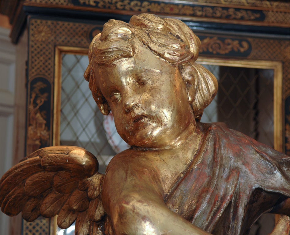 carved Italian wood angels. Original water gilt and siver gilt finish, holding prickets. Great scale and detail