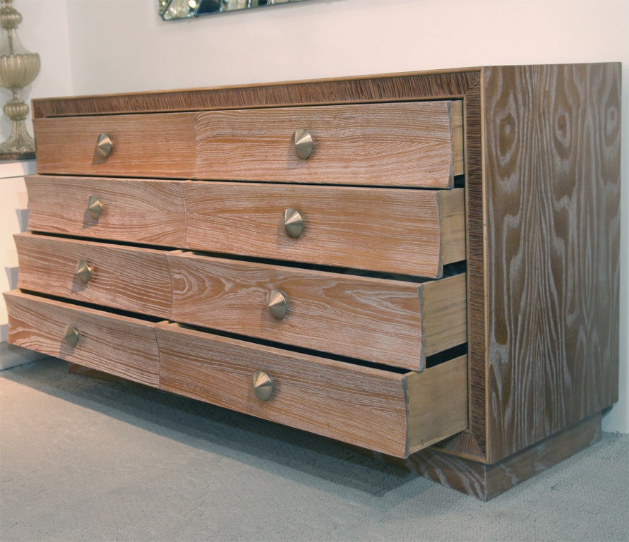 Fully restored 8 concave drawer limed natural oak dresser with a slightly contrasting combed oak border and satin brass knobs. Designed by Paul Frankl for the Brown Saltman Furniture Company.<br />
Visit QUOTIENTNYC.com to view our entire