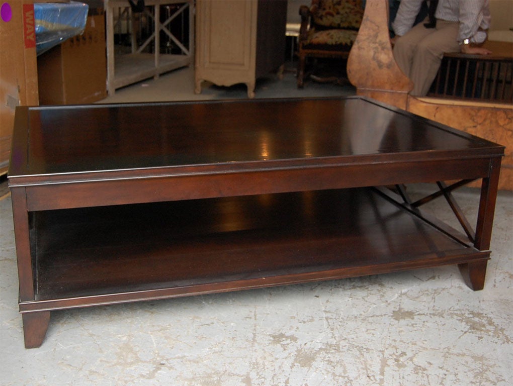 Manhattan cocktail table. Ebonized walnut or mahogany and in two sizes 54" or 60". A striking centerpiece for any room.