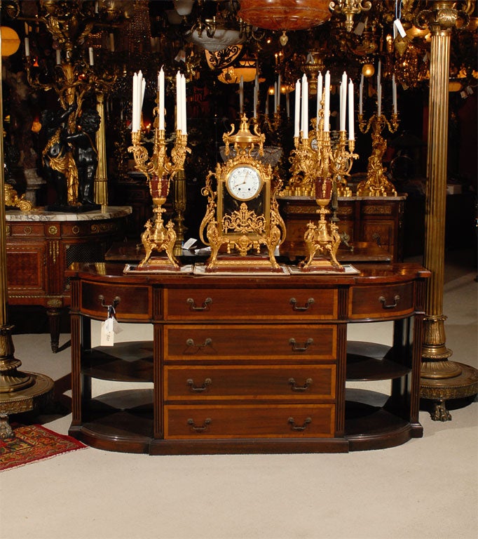 Very fine three piece garniture set, of gilt bronze and Rouge Griotte marble, the clock face signed Thiebaut Freres. The candelabra are 35 inches in height. The clock is 30 inches high and 16 inches wide.