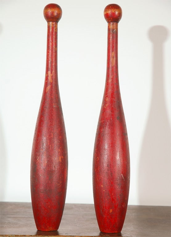 Wonderful 19th century original red painted juggling pins from New England in great simple form and pristine condition. Sold only as a pair at $795.