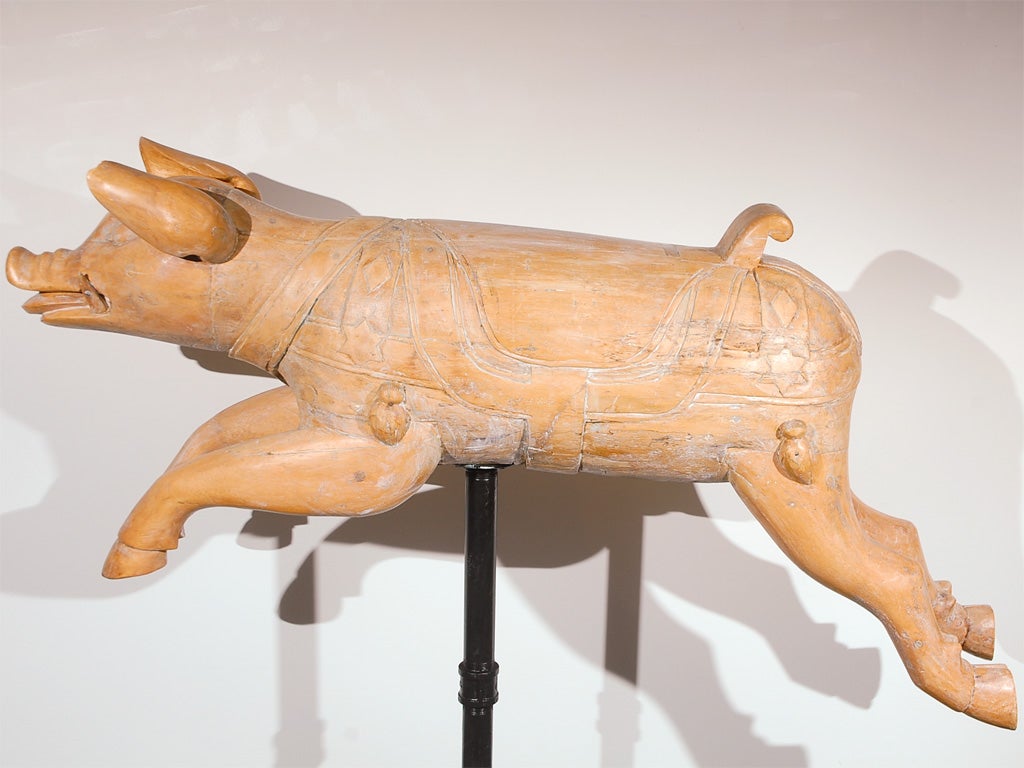 19THC RARE HAND CARVED CAROUSEL PIG FROM A MERRY GO ROUND RIDE IN NEW YORK STATE. THIS FOLKY PIG HAS FRAGMENTS OF ORIGINAL PAINT WITH WONDERFUL SOFT PATINA. THE CARVINGS ARE DONE WITH GREAT DETAIL AND CONDITION IS WONDERFUL. THIS PIG HAS BEEN