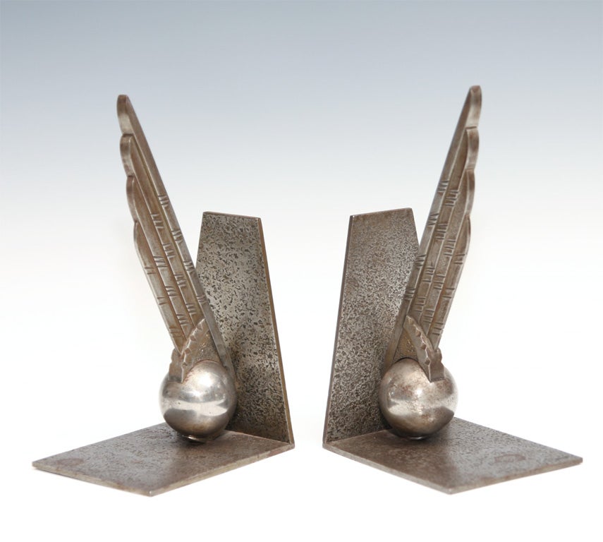 Excellent example of winged ball bookends by master ironsmith Edgar Brandt.  Signature stamped on base.
