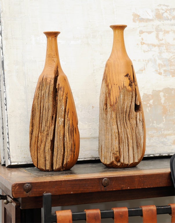 Great pair of very sculptural turned wooden bottles, in the California modernist style of the 1950's.  Look to be constructed from old barnwood or driftwood.  Each bottle has three deeply weathered sides where the artist played up the old grooves
