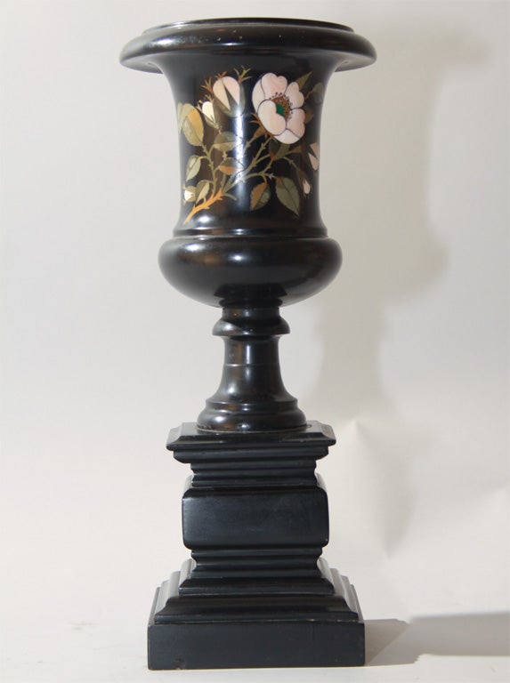 This beautiful antique black marble urn is decorated on its body with a wonderful pietra dura decoration depicting roses. The skill and execution of the flowers and leaves is masterful. This elegant urn is in excellent condition having only a few