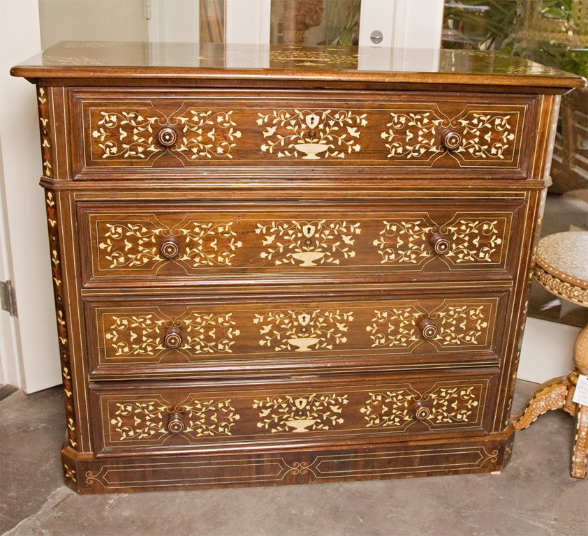 Large South American chest of drawers intricately inlaid, with a rectangular top, canted front corners and four long drawers.